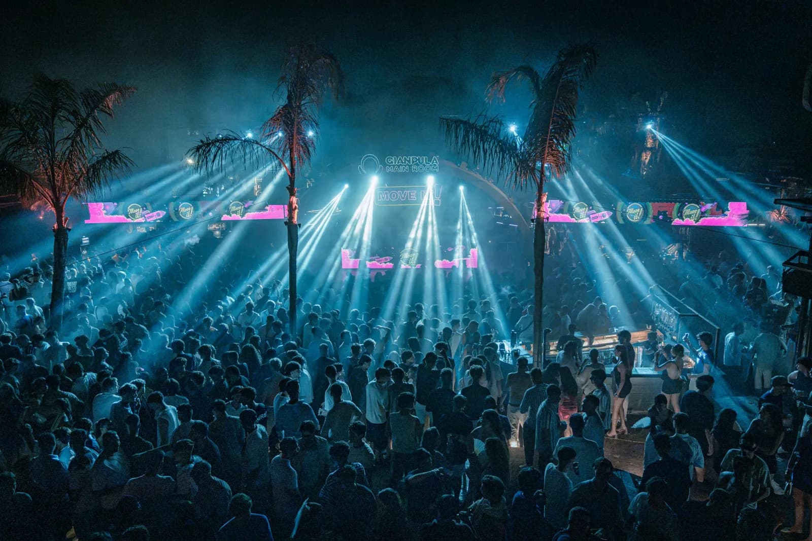 Move it! Malta crowd under the palm trees and light beams of the Main Room at Gianpula Village
